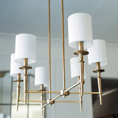 Abbie 6-Light Linear Chandelier in Aged Brass with White Fabric Shades