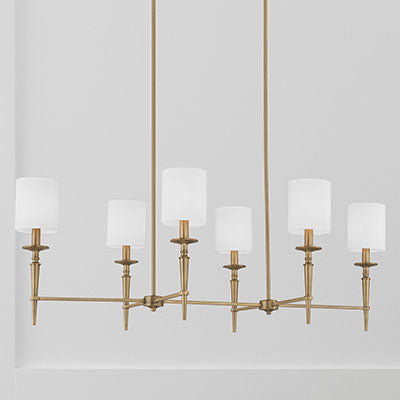 Abbie 6-Light Linear Chandelier in Aged Brass with White Fabric Shades